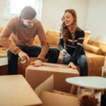 Packing List - Man and Woman Packing Boxes