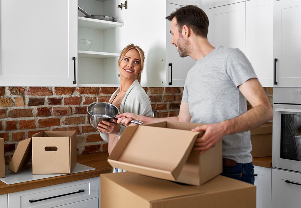 Man and Woman Unpacking Pots and Pans into New Apartment | Moving During Winter Tips