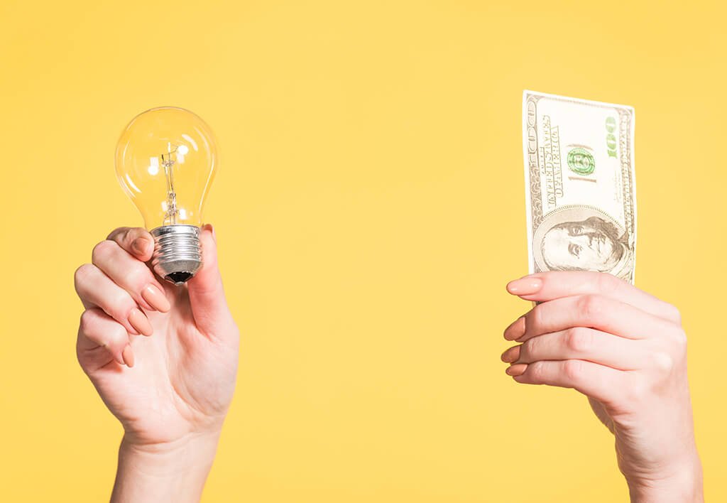 Picture of Light Bulb and One Hundred Dollar Bill | How to Lower You Electric Bills