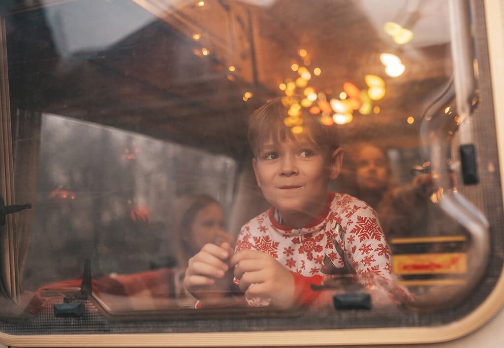 Boy in Christmas Pajamas Looking Out Window of West Chester Santa Express Train Ride