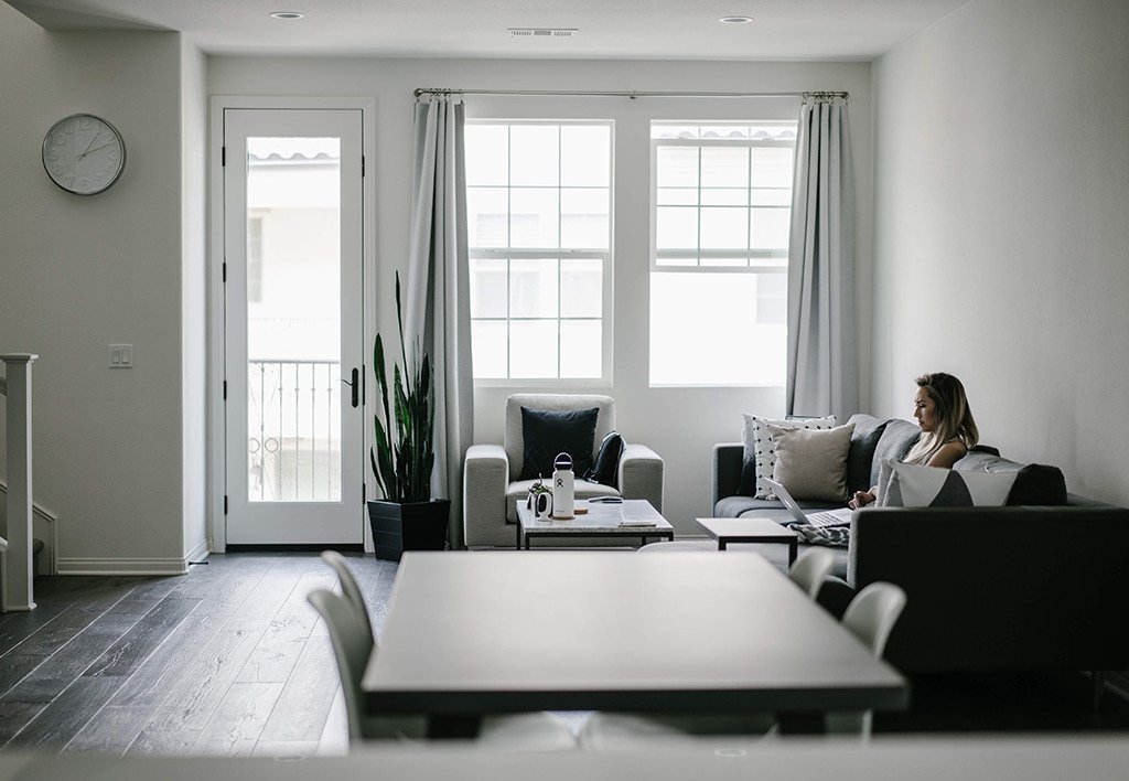 Modern Minimalist Apartment Design - Woman Sitting in Minimalist White and Black Apartment