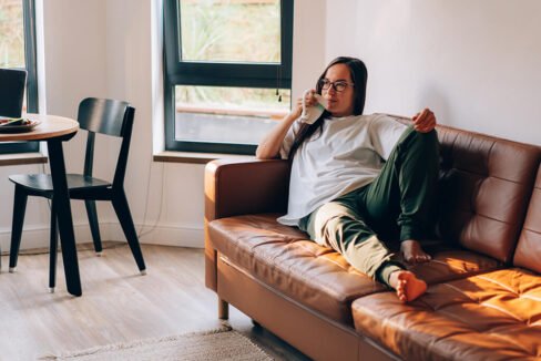 Apartment Relaxation Zone | Women on Apartment Couch Relaxing