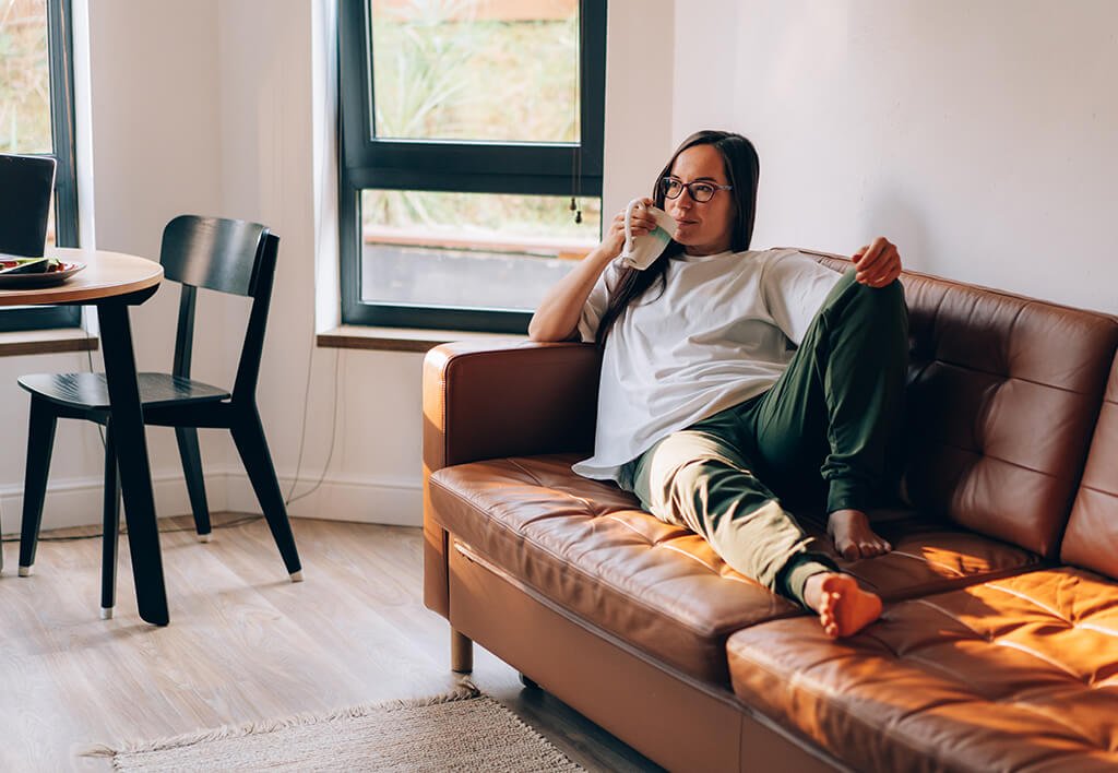 Apartment Relaxation Zone | Women on Apartment Couch Relaxing
